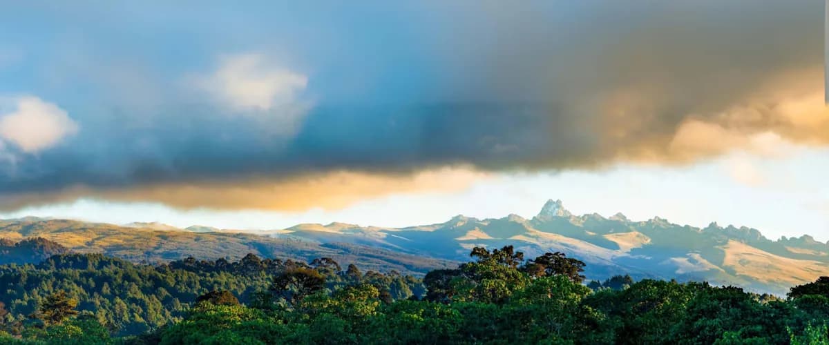 Forested slopes of Mount Kenya beneath dramatic cloud