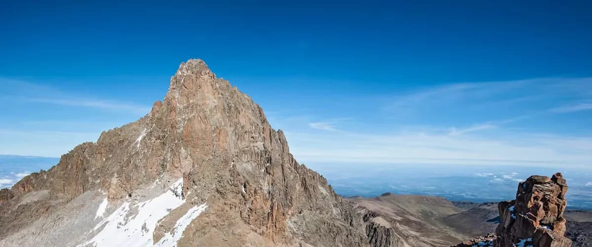 Mount Kenya's main peaks under a blue sky
