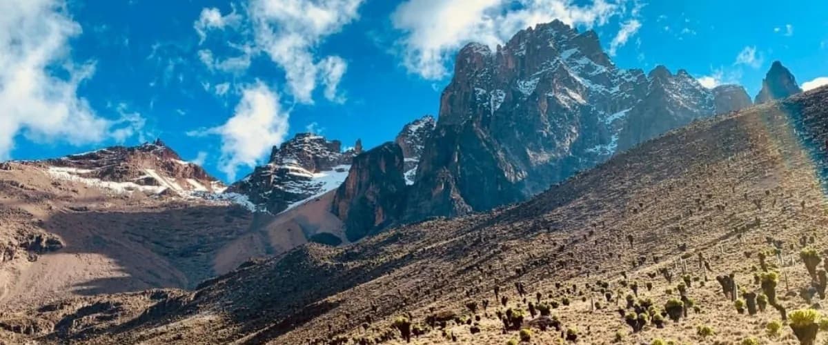 Rugged peaks of Mount Kenya above scree slopes