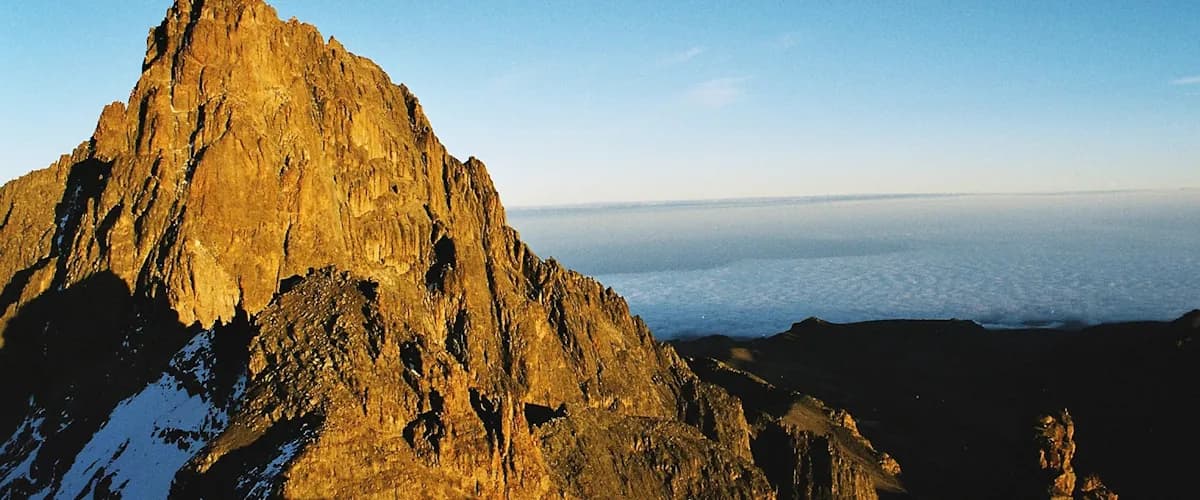 Sunrise lighting the rock face of Mount Kenya