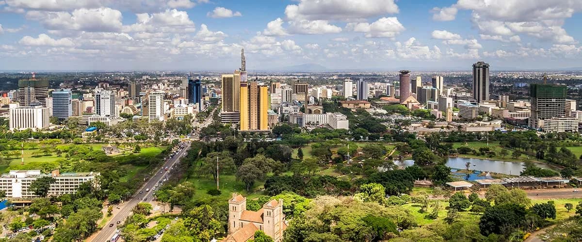 Aerial view of central Nairobi surrounded by green trees